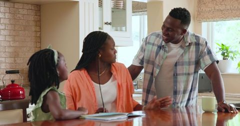 Family Enjoying Quality Time Reading at Dining Table Together