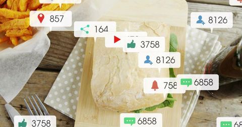 Ciabatta sandwich on rustic table showing floating social media icons for food engagement
