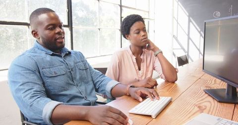 Business Professionals Collaborating on Project at Office Desk