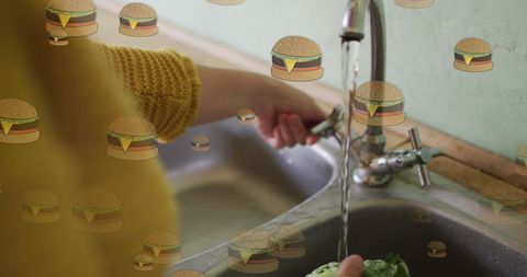 Caucasian woman washing lettuce with overlayed hamburger icons