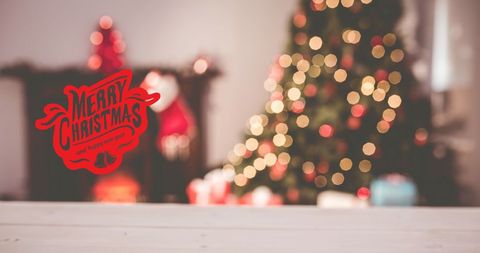 Festive Christmas Greeting Over Decorated Tree with Warm Bokeh