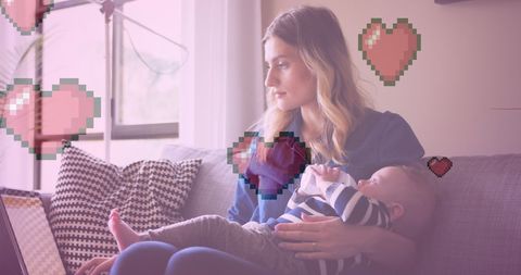 Mother Holding Baby Surrounded by Heart Icons in Lifestyle Concept