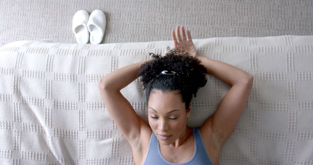 Woman Relaxing on Sofa with Arms Behind Head in Comfortable Home Setting - Download Free Stock Images Pikwizard.com