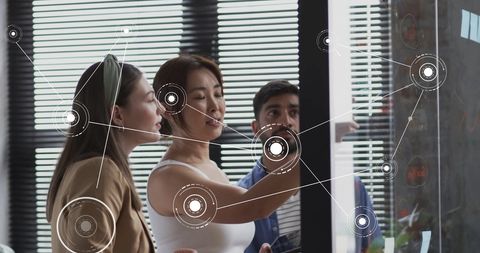 Team Collaborating on Digital Strategy with Data Visualization in Office