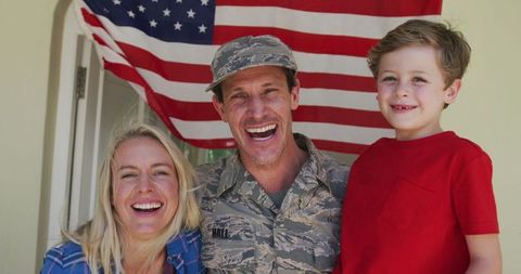 Military Homecoming: Soldier with Joyful Family and American Flag