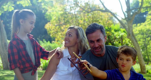 Happy Family Enjoying Time Outdoors in Garden - Download Free Stock Images Pikwizard.com