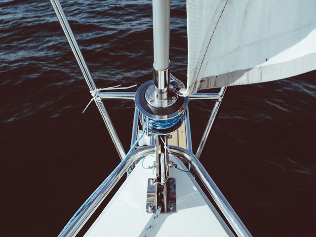 Yacht bow details seen from above with calm ocean background. Useful for travel, nautical businesses, and adventure-related content. Can illustrate concepts related to luxury, leisure activities, marine travel, and boating experiences.