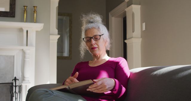 Elderly Woman Reading Book on Couch in Living Room - Download Free Stock Images Pikwizard.com