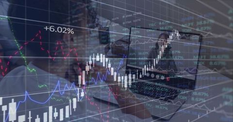 Businesswoman analyzing financial data on laptop with stock market overlay