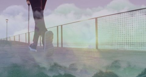 Surreal Fitness Scene: Runner on Beach Path Among Clouds