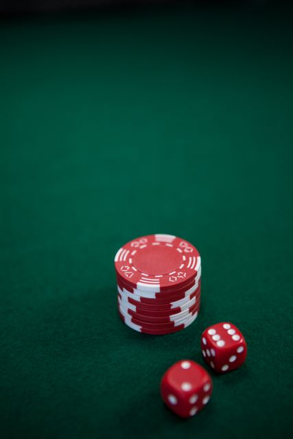 Pairs of dice and casino chips on poker table in casino