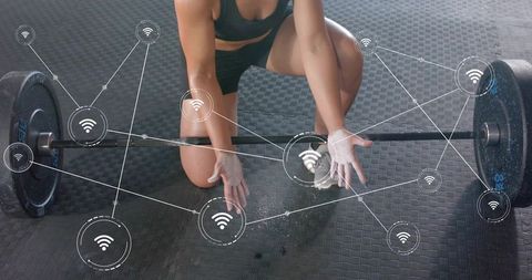 Kneeling athlete reaching barbell chalked hands augmented reality fitness analytics