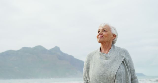 Senior Woman Enjoying Serene Beach Scenery - Download Free Stock Images Pikwizard.com