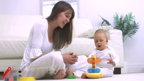 Mother Engaging with Infant in Bright Playroom