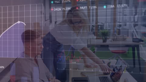 Colleagues Analyzing Financial Data with Advanced Graphs Overlay