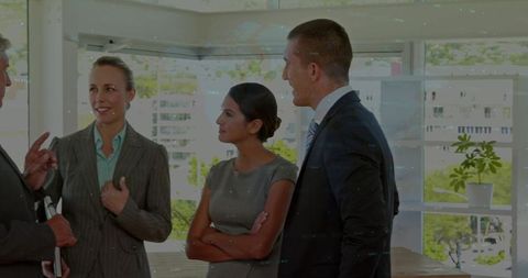 Discussing business strategy in modern office with diverse professional team collaboration