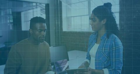 Colleague Discussing Digital Project in Modern Office