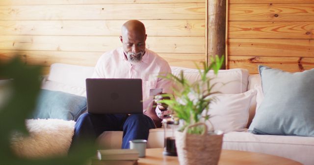 Relaxed Senior Man Working on Laptop at Home with Coffee - Download Free Stock Images Pikwizard.com