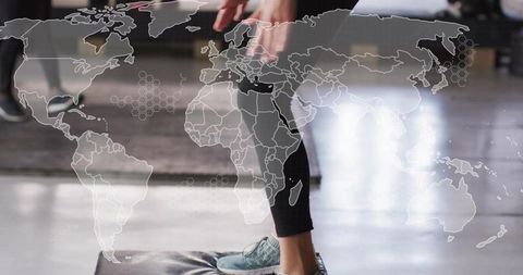 Woman stepping on padded platform with teal shoes and world map overlay fitness concept