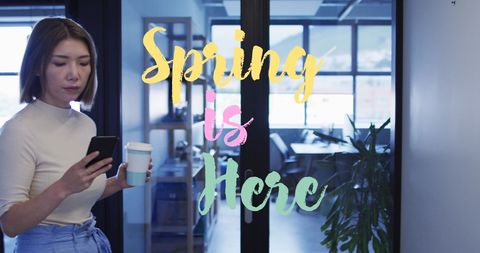 Businesswoman enjoying spring with coffee and smartphone