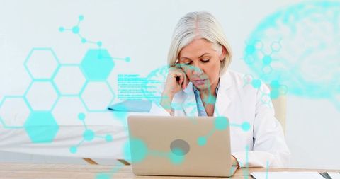 Senior Female Doctor Analyzing Medical Data on Laptop with Tech Overlays