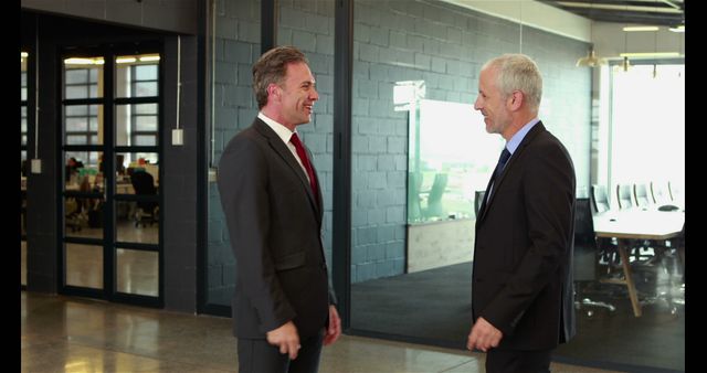 Two Businessmen in Formal Suits Having a Conversation in Modern Office - Download Free Stock Images Pikwizard.com