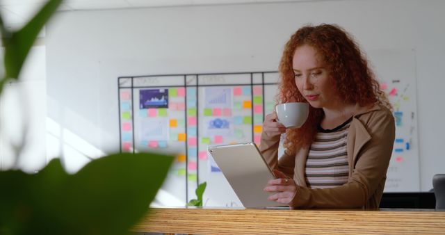 Businesswoman Working with Tablet and Coffee in Office - Download Free Stock Images Pikwizard.com