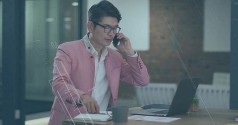 Executive Asian Businessman Multitasking at Modern Workplace