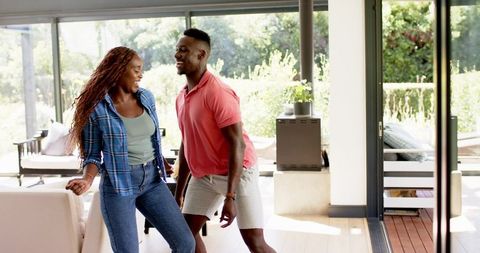 Couple Dancing Together in Modern Living Room City Views