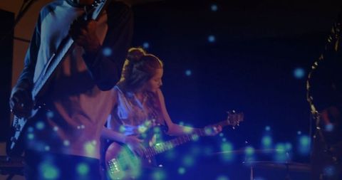 Electric Guitar Performance with Vibrant Blue Effects on Stage