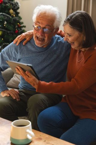 Senior Couple Enjoying Technology and Holiday Spirit Together