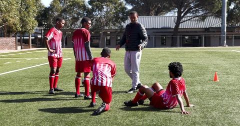 Soccer Coach Instructing Young Players During Outdoor Practice