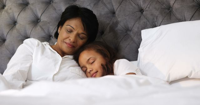 Peaceful Sleep of Grandmother and Granddaughter in Comfortable Bed - Download Free Stock Images Pikwizard.com