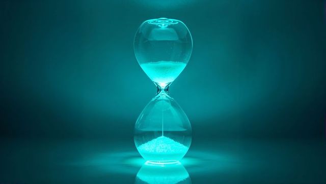 Hourglass with neon lighting symbolizing time and precision