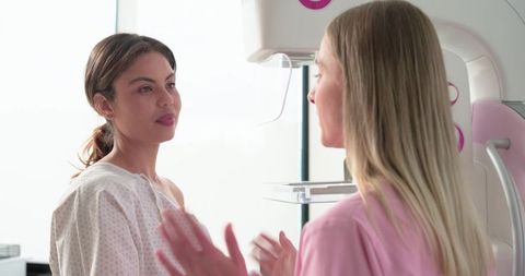 Female Patient Receiving Mammogram with Caring Technician in Bright Medical Clinic