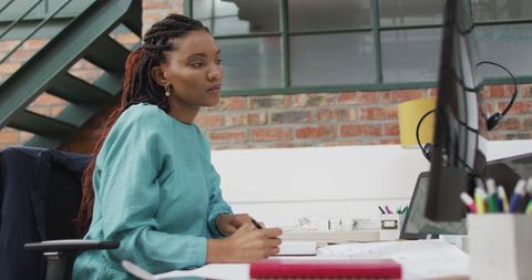 Thoughtful African American Businesswoman in Creative Office