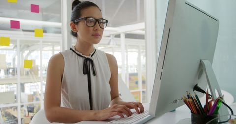 Focused Woman Working at Office Computer in Modern Workspace - Download Free Stock Images Pikwizard.com