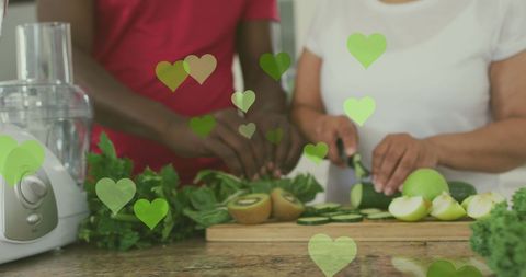 Senior Couple Cooking Together in Kitchen with Heart Overlay
