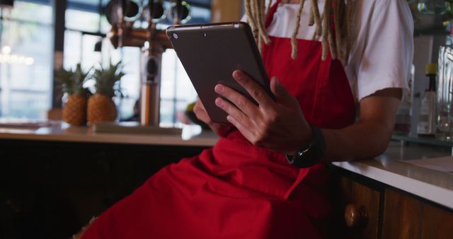 Cafe Worker Using Digital Tablet in Trendy Cafe Setting - Download Free Stock Images Pikwizard.com