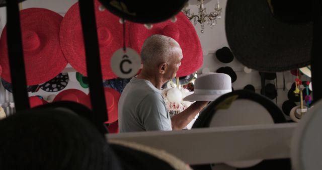 Man Selecting Hat in Colorful Hat Shop - Download Free Stock Images Pikwizard.com