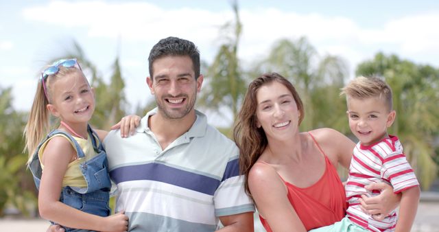 Happy Family of Four Enjoying Sunny Outdoor Time - Download Free Stock Images Pikwizard.com