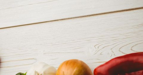 Fresh organic vegan vegetables on wooden surface