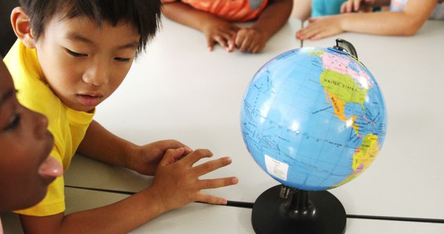 Curious Children Observing Globe During Geography Class - Download Free Stock Images Pikwizard.com