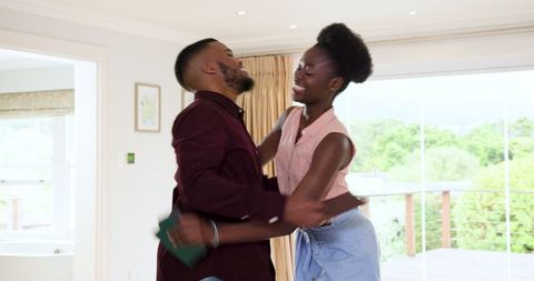 Joyful Couple Packing for Upcoming Vacation at Home