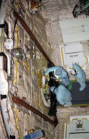 Technicians repairing space shuttle columbia hatch in kennedy space center