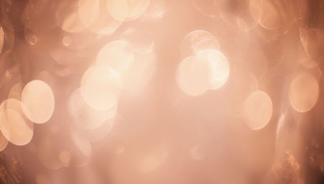 Glowing Rose Gold Bokeh Background with Soft Circular Light Orbs