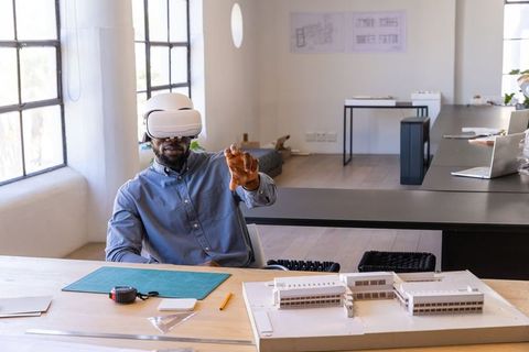 African american architect using vr headset exploring modern building model design lab