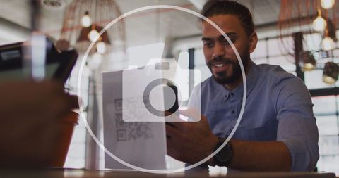 Biracial Businessman Engaged in Data Processing at Workplace