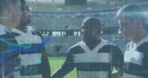 Rugby Players Analyzing Game Data in Stadium Overview