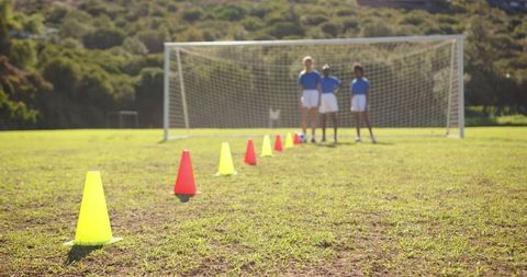 Youth Soccer Training with Colorful Cones on Field